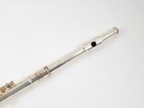 a flute that is sitting on a white surface