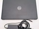 a dell laptop with a charger attached to it