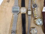 a lot of watches that are on a wooden table