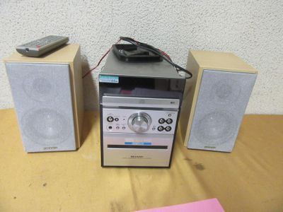 two speakers and a remote on a table