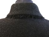 the back of a black jacket with fringes on a mannequin mannequin mannequin mannequin mannequin mannequin mannequin