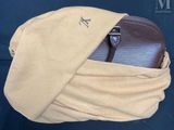 a brown purse with a tan scarf around it