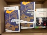 books in a cardboard box on a table in a room