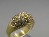 an image of a gold and diamond ring on a white surface