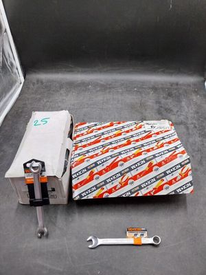 a piece of paper and a wrench on the floor