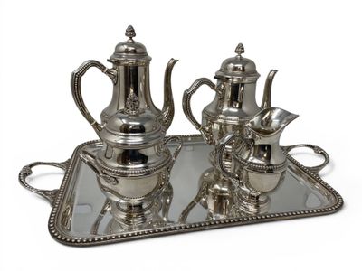 a silver tray with a silver tea set on it