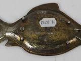 an image of a metal fish with a tag on it ' s side