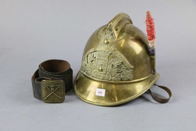 a gold fireman ' s helmet next to a brush