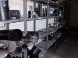 a room with a lot of shelves filled with pots and pans