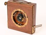 a small wooden box with a camera attached to it