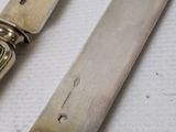 two knives and a knife holder on a table