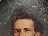portrait of a man in a tuxedo and bow tie in a gold frame