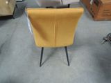 a yellow chair that is sitting in the middle of a room