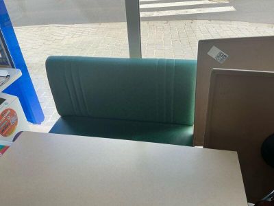 a table with two chairs and a laptop on it