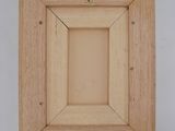 an image of a wooden picture frame with a gold ring on it