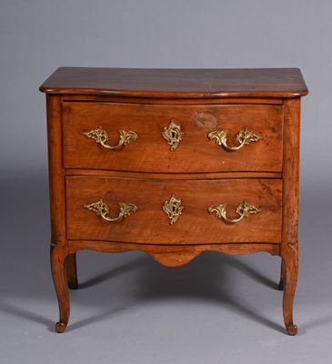 an image of a wooden chest of drawers with brass handles