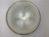 a white plate with a design on it on the wall