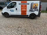 a van that is parked in the gravel