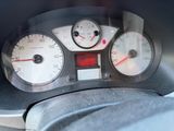 a close up of a car dashboard with a speedometer and gauges