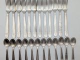 a lot of silver spoons and spoons on the table