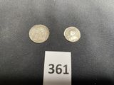 a close up of two coins on a table with a price tag