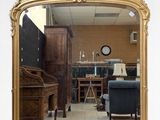 a large mirror that has a painting on the side of it