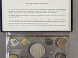 an assortment of coins in a plastic case on a table