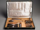 a case with silverware in it on a gray surface