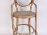 a wooden chair with a wicker seat on a white background