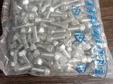 a bag of screws and nuts on a table