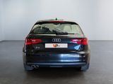 the rear end of a black audi car in a white room
