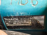 a close up of a blue machine with a sticker on it