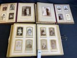 several old photos of people are displayed on a table