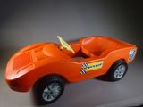 an orange toy car with a checkered flag on it