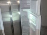an empty refrigerator in the corner of a room