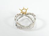 a close up of a silver and gold ring on a white surface
