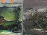 two paintings that are on a easel in a room