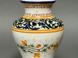 a vase with a design on it on a gray surface