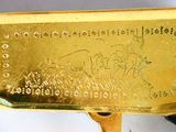 someone is holding a gold plate with a picture of a man on a horse