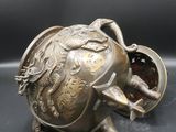 an antique brass teapot with a lid and a handle
