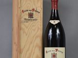 a bottle of wine sitting next to a wooden box