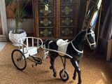 a toy horse pulling a carriage in a living room