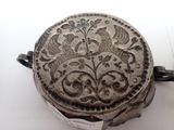 a silver box that has a floral design on it