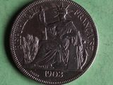 an image of a coin on a green surface with a picture of a woman holding a flag