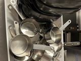 many pots and pans in this kitchen on the shelf
