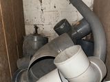 a pile of plumbing pipes and pipes in a room