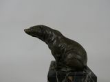 statue of a polar bear sitting on a marble block