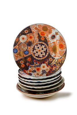 many plates stacked on top of each other on a white surface