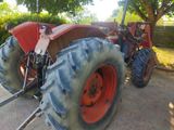 a tractor that is parked on the side of the road