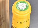 a bottle of wine that is sitting next to a wooden box